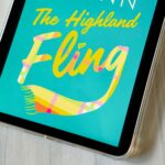 The cover of the book The Highland Fling by Meghan Quinn is on the screen of an iPad.