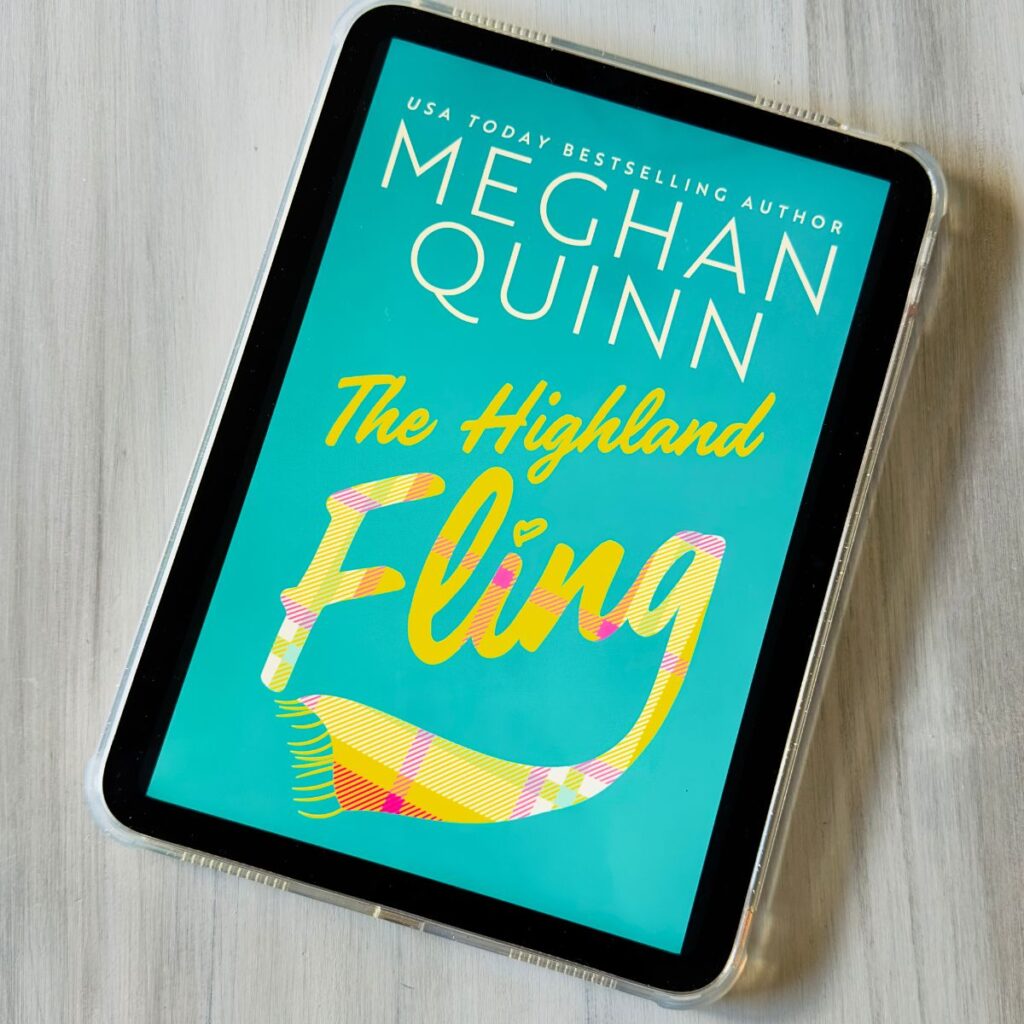 The cover of the book The Highland Fling by Meghan Quinn is on the screen of an iPad.