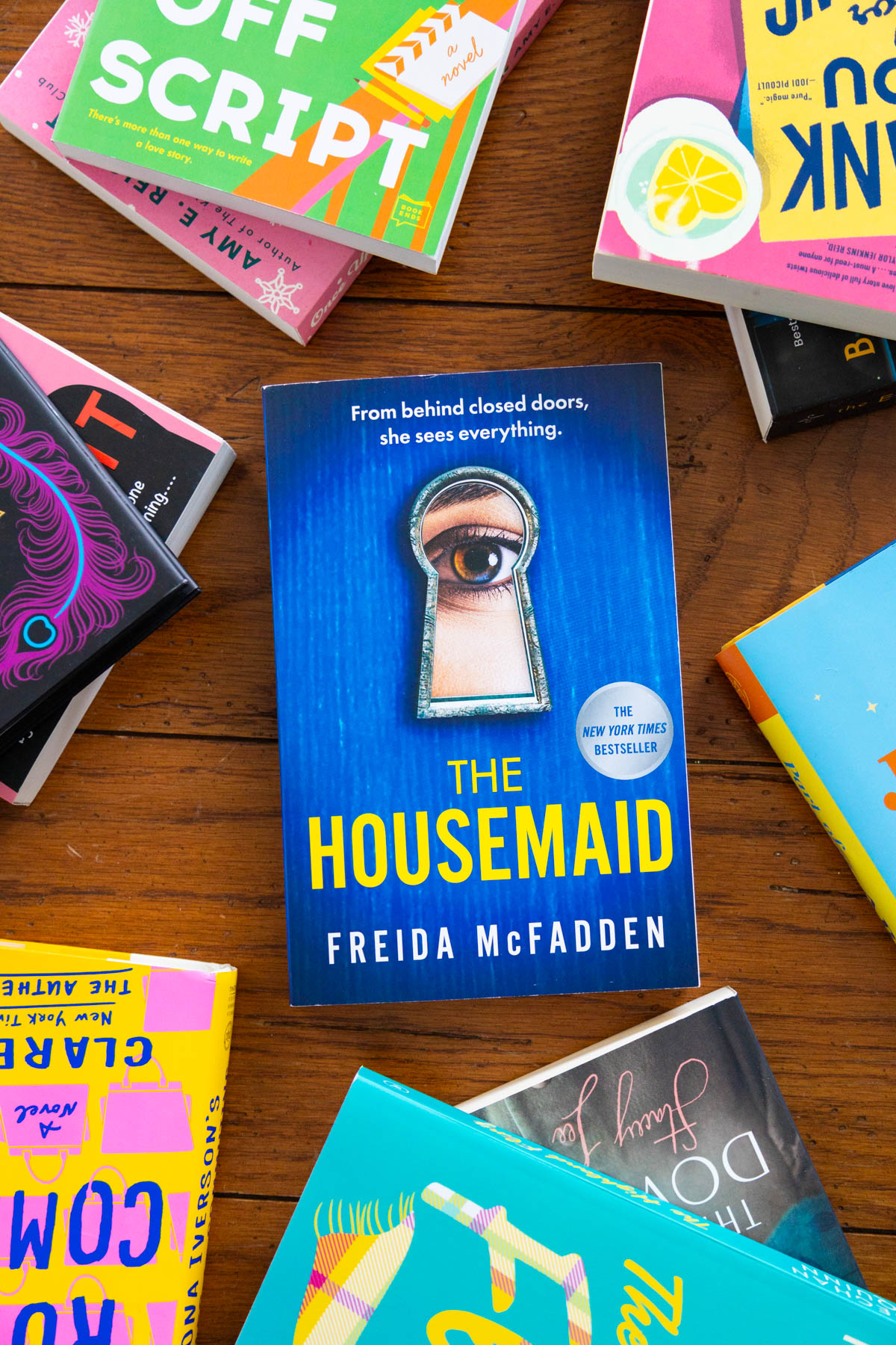 A copy of the book The Housemaid by Freida McFadden is on the table.