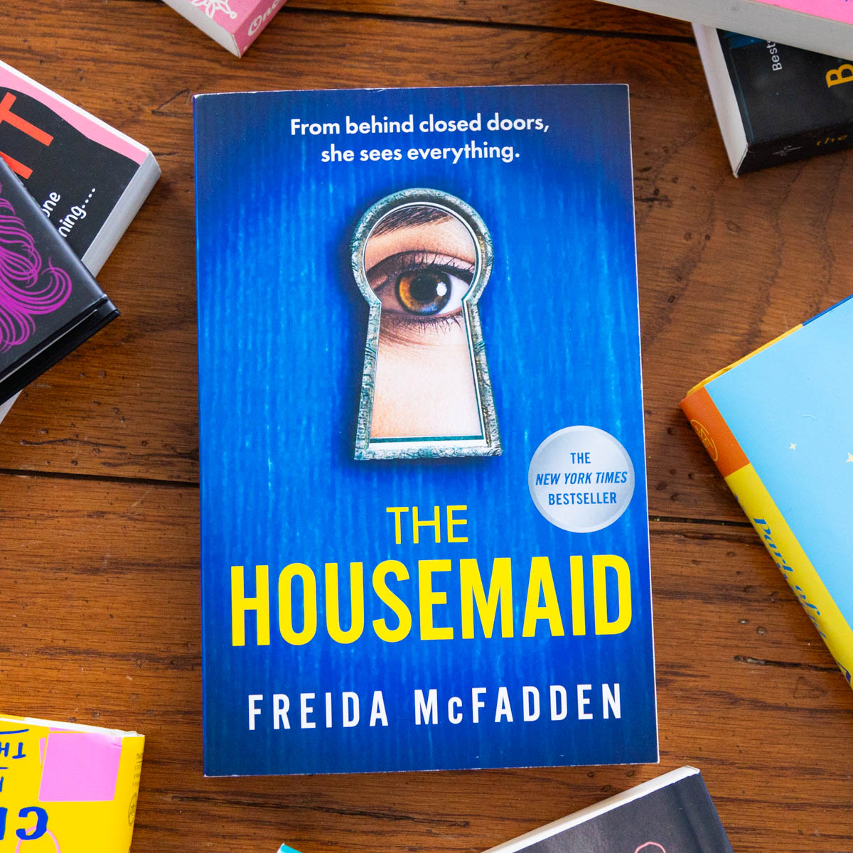 A copy of the book The Housemaid by Freida McFadden is on the table.