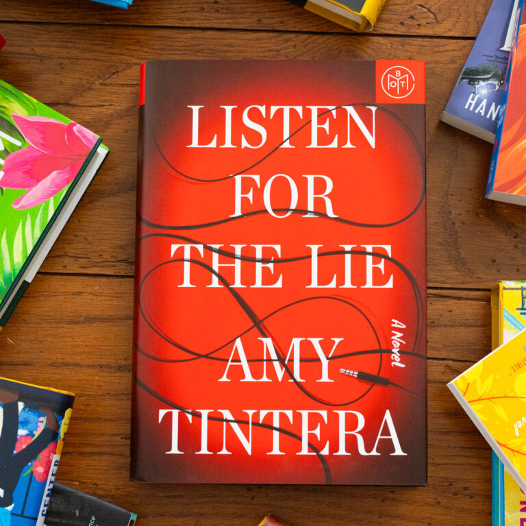 A copy of Listen for the Lie by Amy Tintera sits on the table.