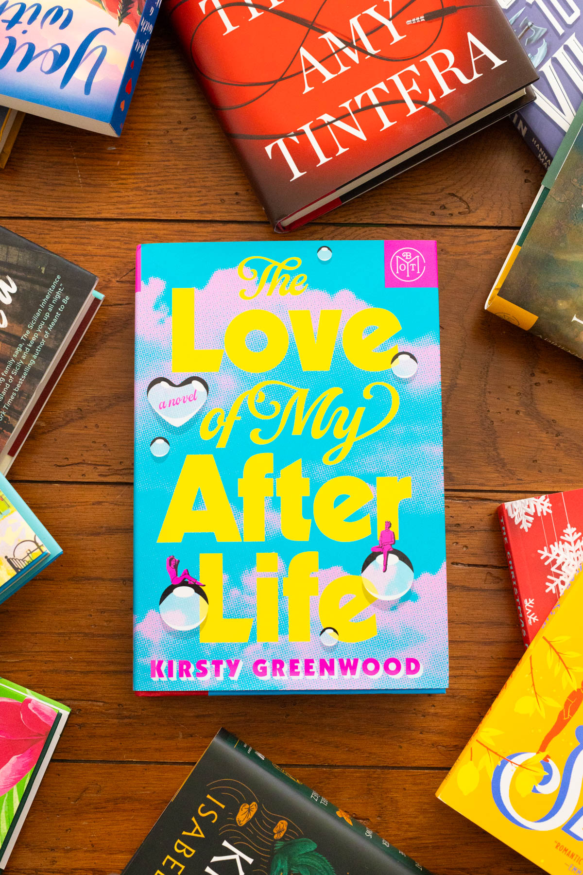 A copy of The Love of My After Life by Kirsty Greenwood sits on the table.