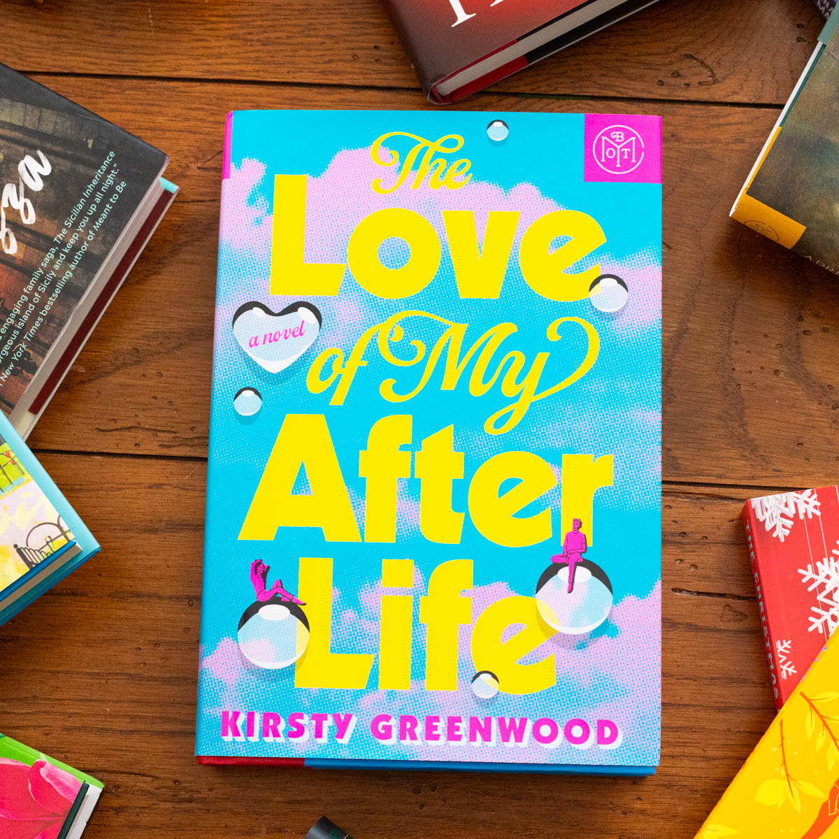 A copy of the book The Love of My After Life by Kirsty Greenwood sits on the table.