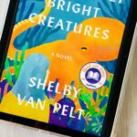 A cover of the book Remarkably Bright Creatures by Shelby Van Pelt is on the screen of an iPad.