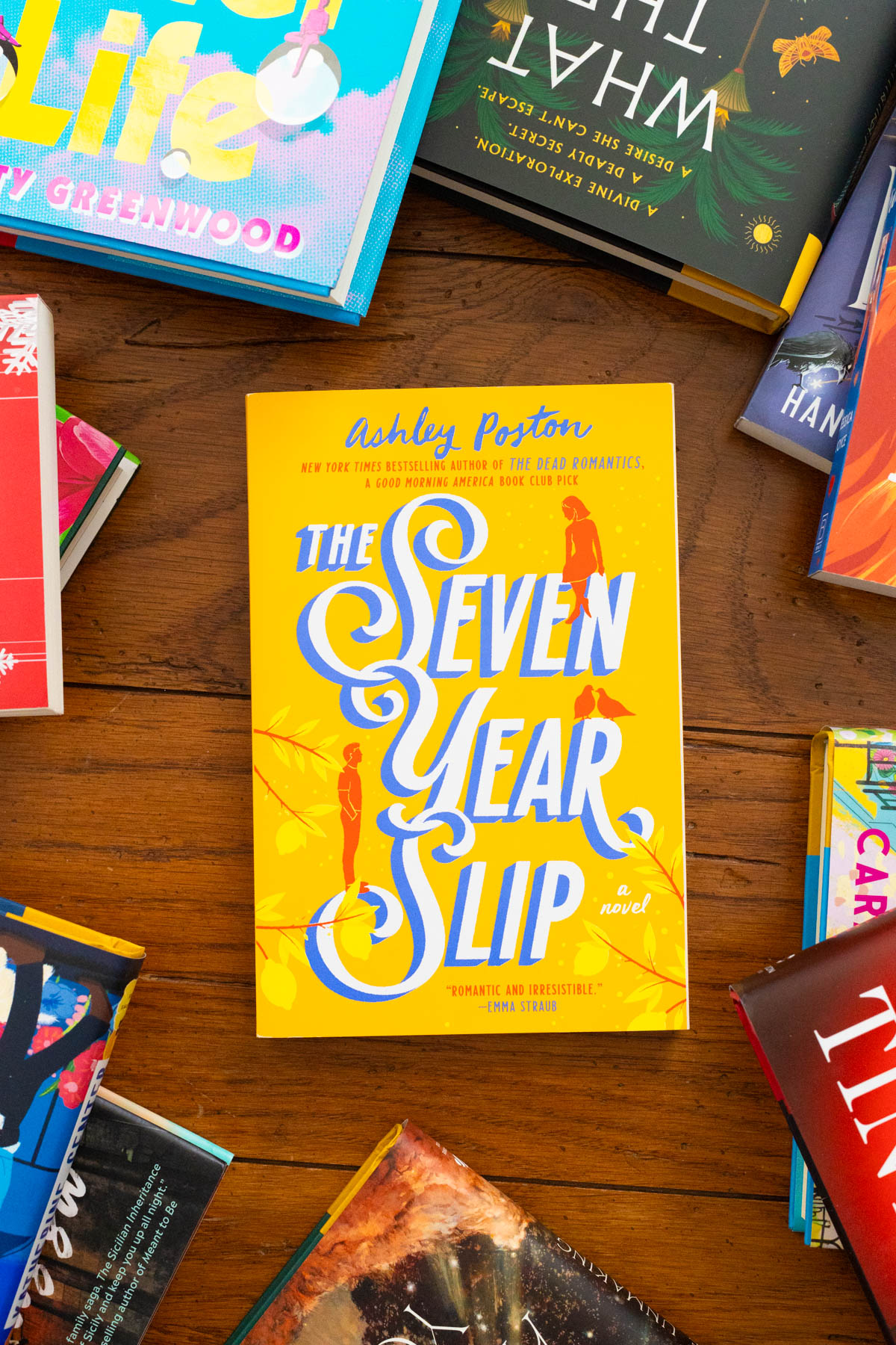 A copy of the book The Seven Year Slip by Ashley Poston sits on the table.