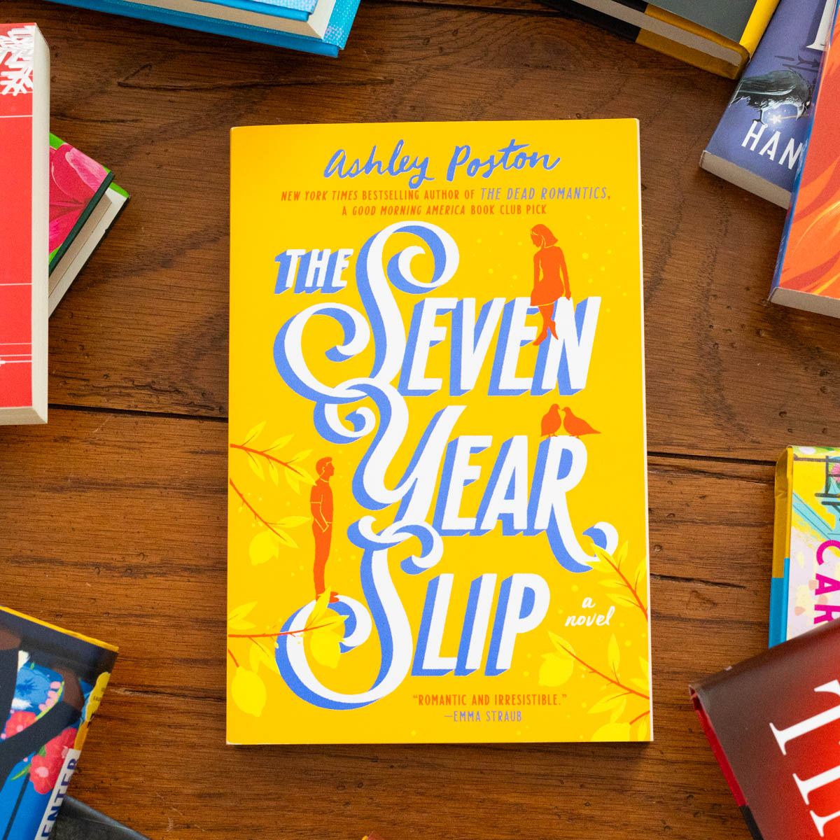 A copy of the book The Seven Year Slip by Ashley Poston is on the table.