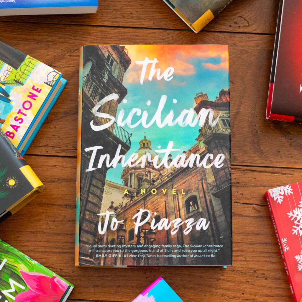 A copy of the book The Sicilian Inheritance by Jo Piazza sits on the table.