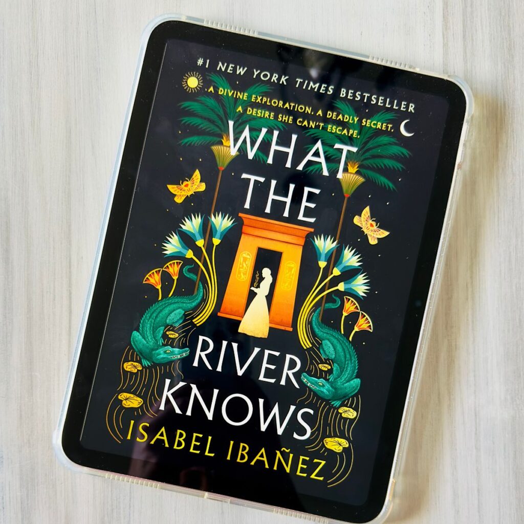 A copy of the book What the River Knows by Isabel Ibañez is on the screen of an iPad.