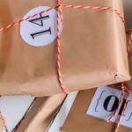 Several brown paper wrapped packages with numbers and tied up with red striped string.