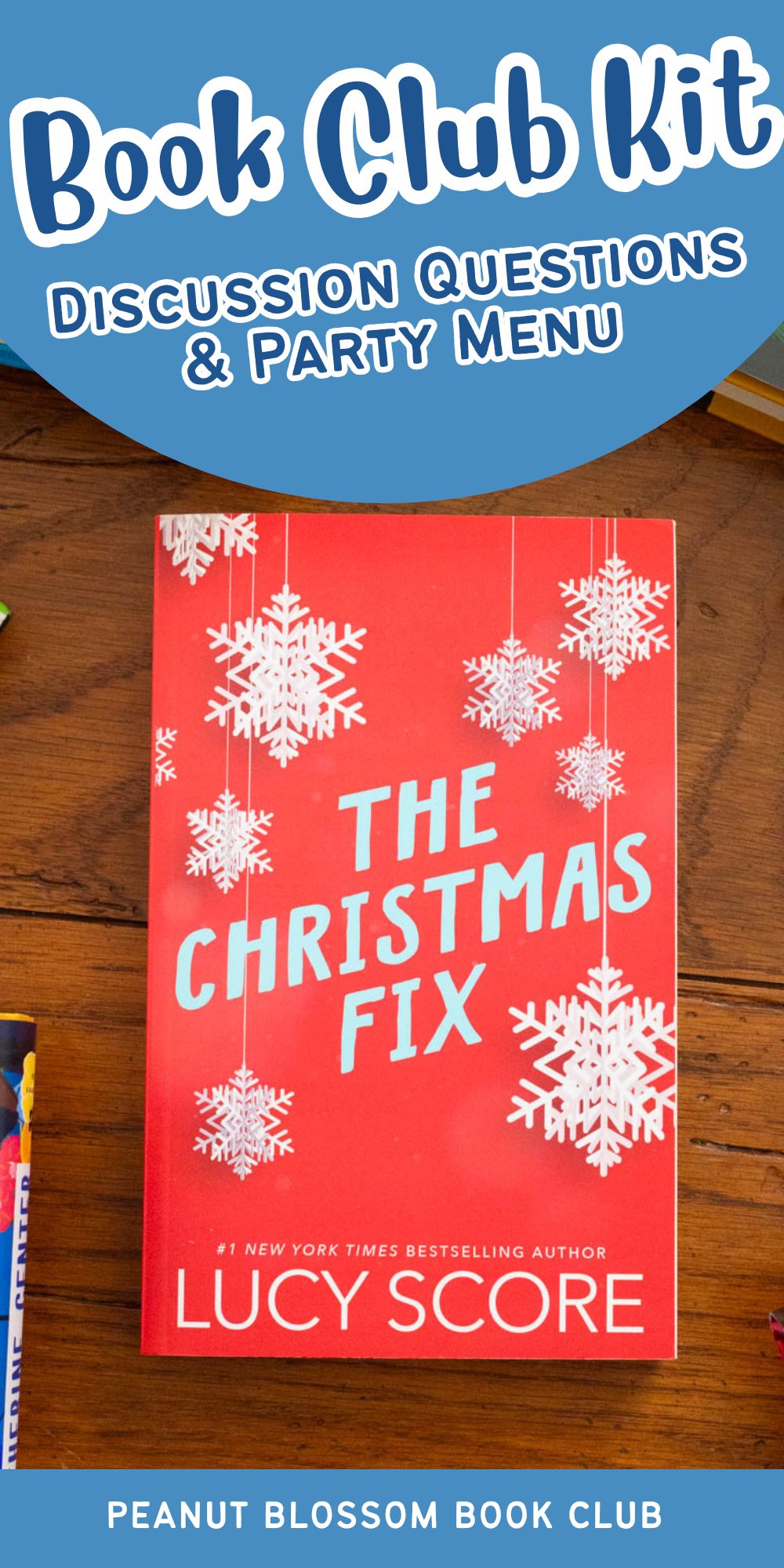 A copy of the book The Christmas Fix by Lucy Score sits on the table.