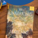 A copy of the book The Unmaking of June Farrow by Adrienne Young sits on the table.