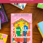 A copy of Once Upon a December by Amy E. Reichert sits on the table.