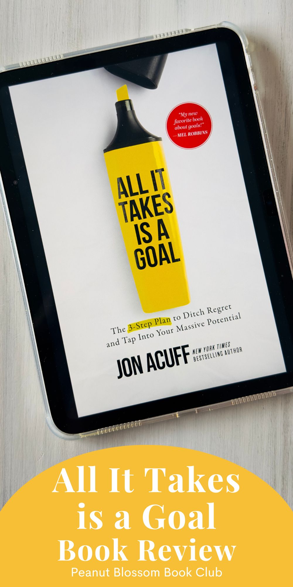 The cover of All It Takes is a Goal by Jon Acuff is on the screen of an ipad.