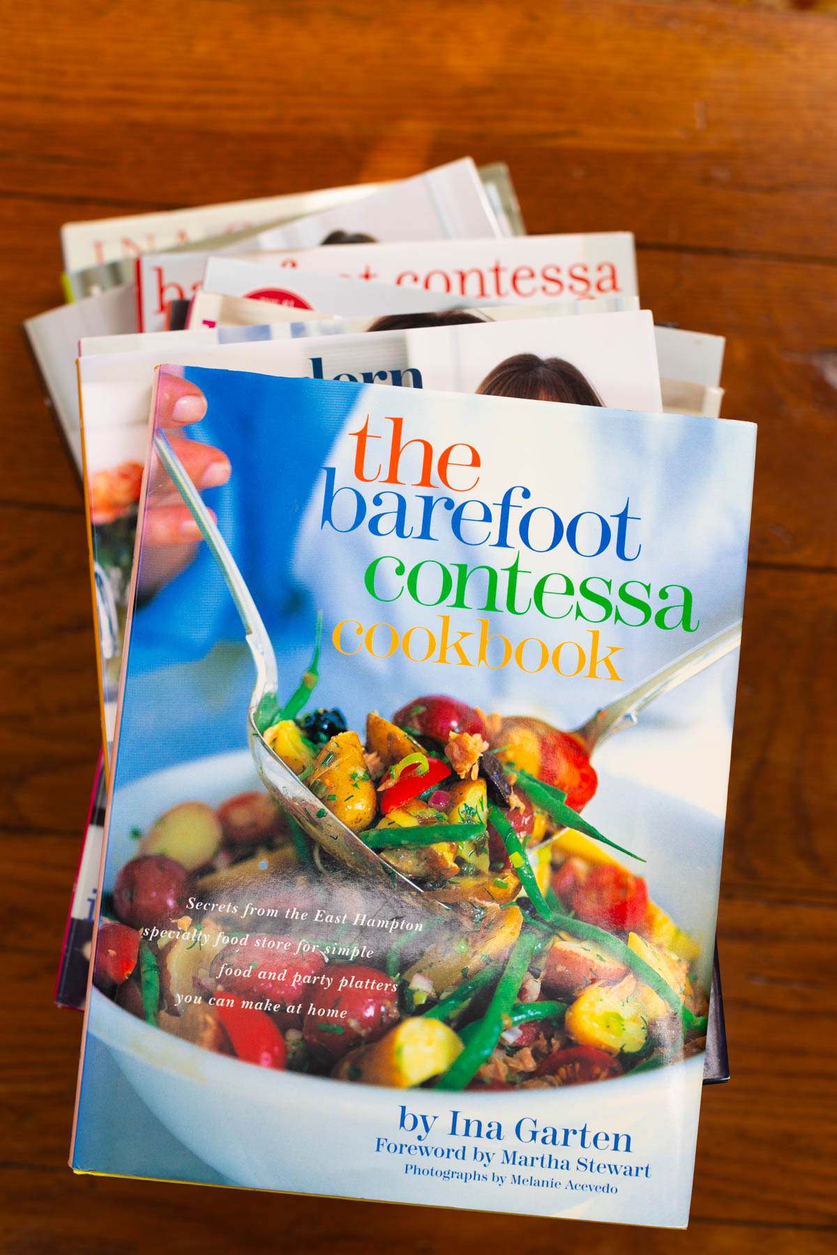 The stack of cookbooks has a copy of the first Barefoot Contessa Cookbook on top.