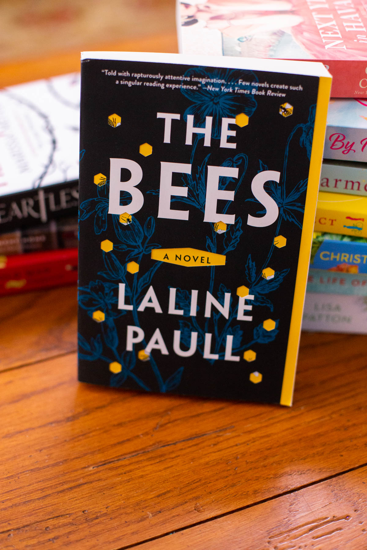 The copy of the book The Bees sits on a table.