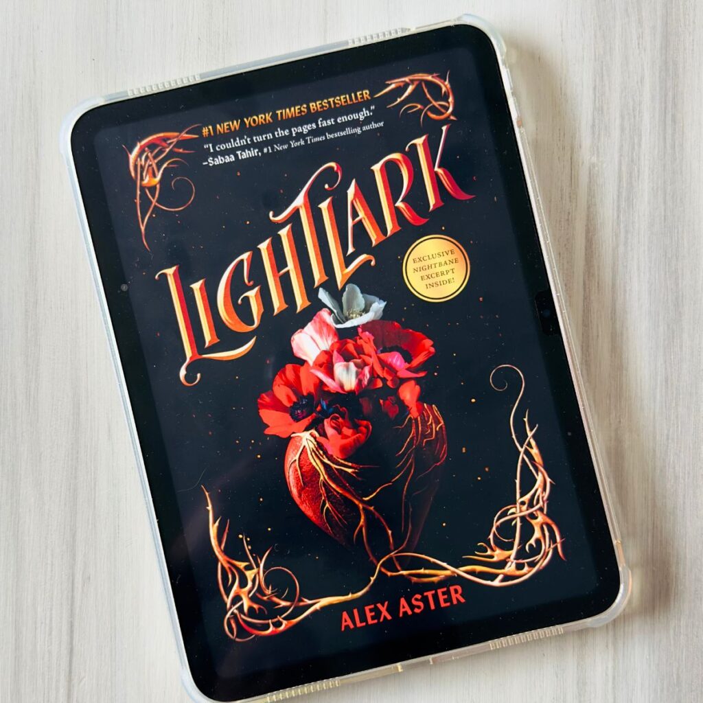 The cover of Lightlark by Alex Aster is on the screen of an iPad.