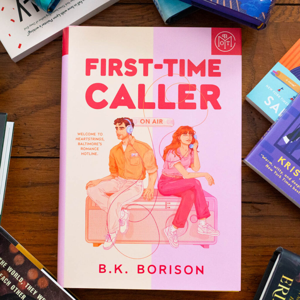 A copy of First-Time Caller by B.K. Borison sits on the table.