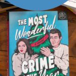 A copy of The Most Wonderful Crime of the Year by Ally Carter sits on the table.