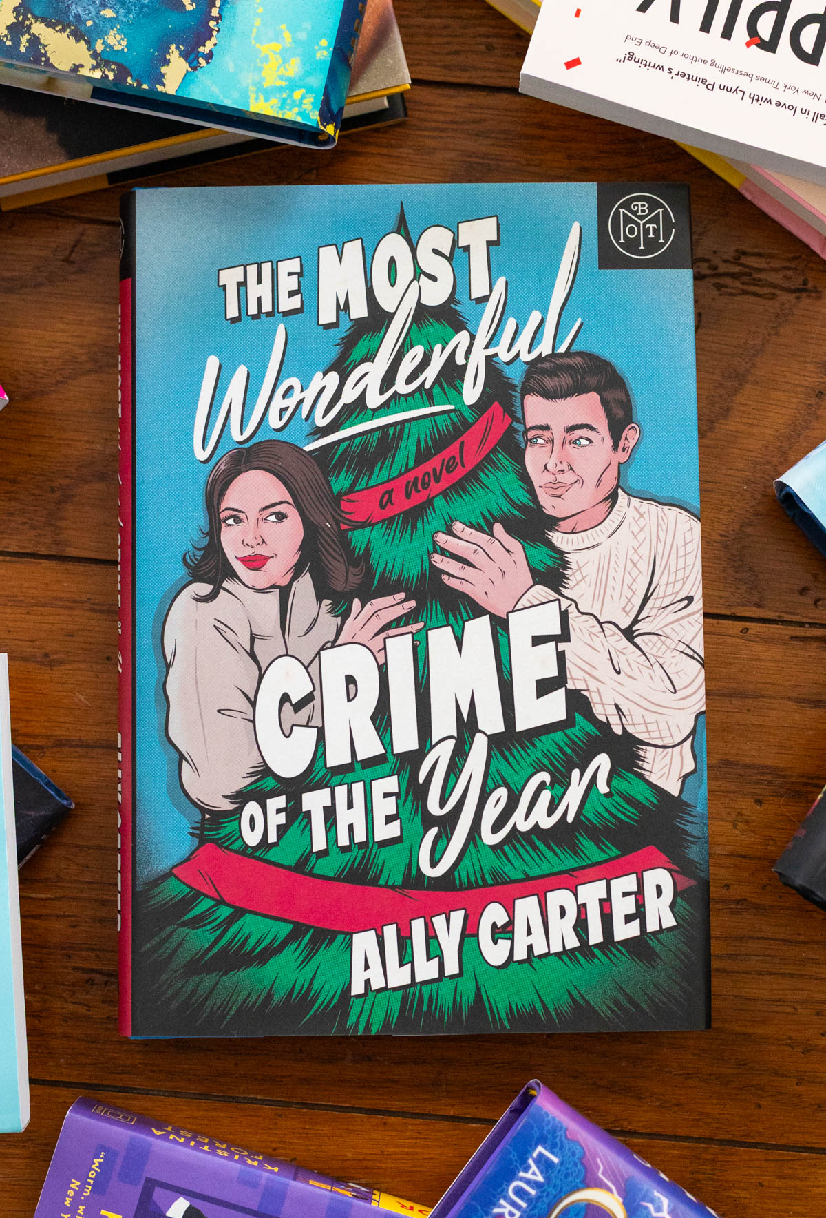 A copy of The Most Wonderful Crime of the Year by Ally Carter sits on the table.