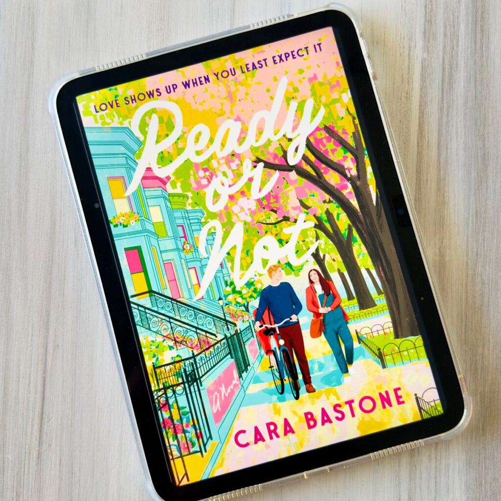 The cover of the book Ready or Not by Cara Bastone is on the screen of an ipad.