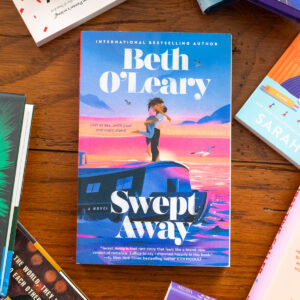 A copy of Swept Away by Beth O'Leary sits on the table.