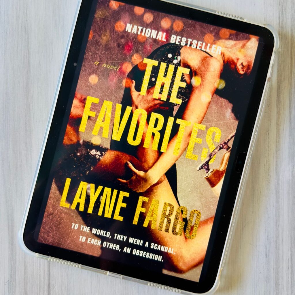 The cover of the book The Favorites by Layne Fargo is on the screen of an ipad.