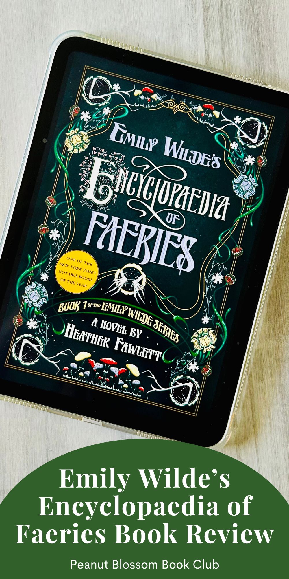 The cover of the book Emily Wilde's Encyclopaedia of Faeries by Heather Fawcett is on the screen of an iPad.