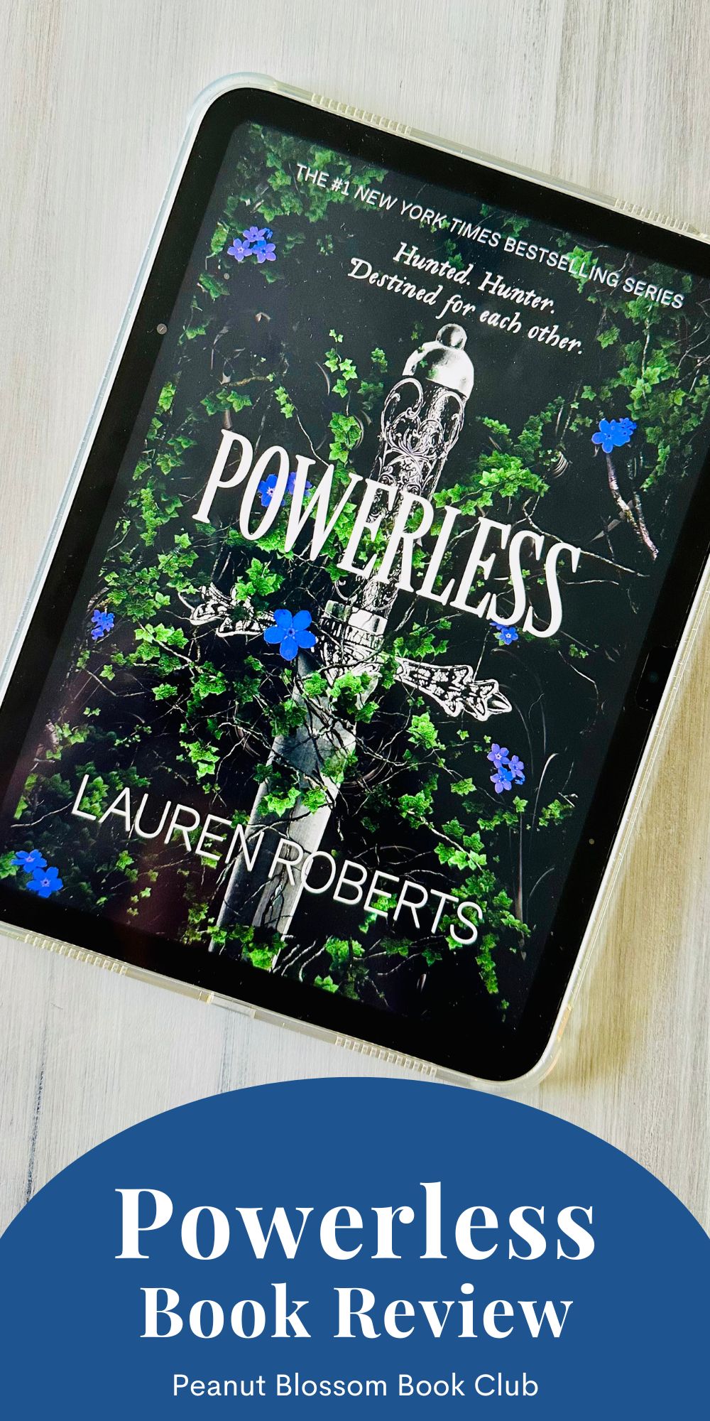 The cover of the book Powerless by Lauren Roberts is on the screen of an iPad.