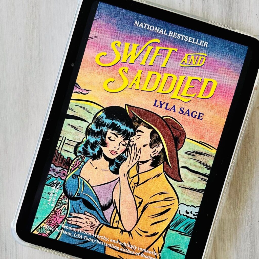 The cover of the book Swift and Saddled by Lyla Sage is on the screen of an iPad.