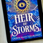 The cover of the book Heir of Storms by Lauryn Hamilton Murray is on the iPad screen.