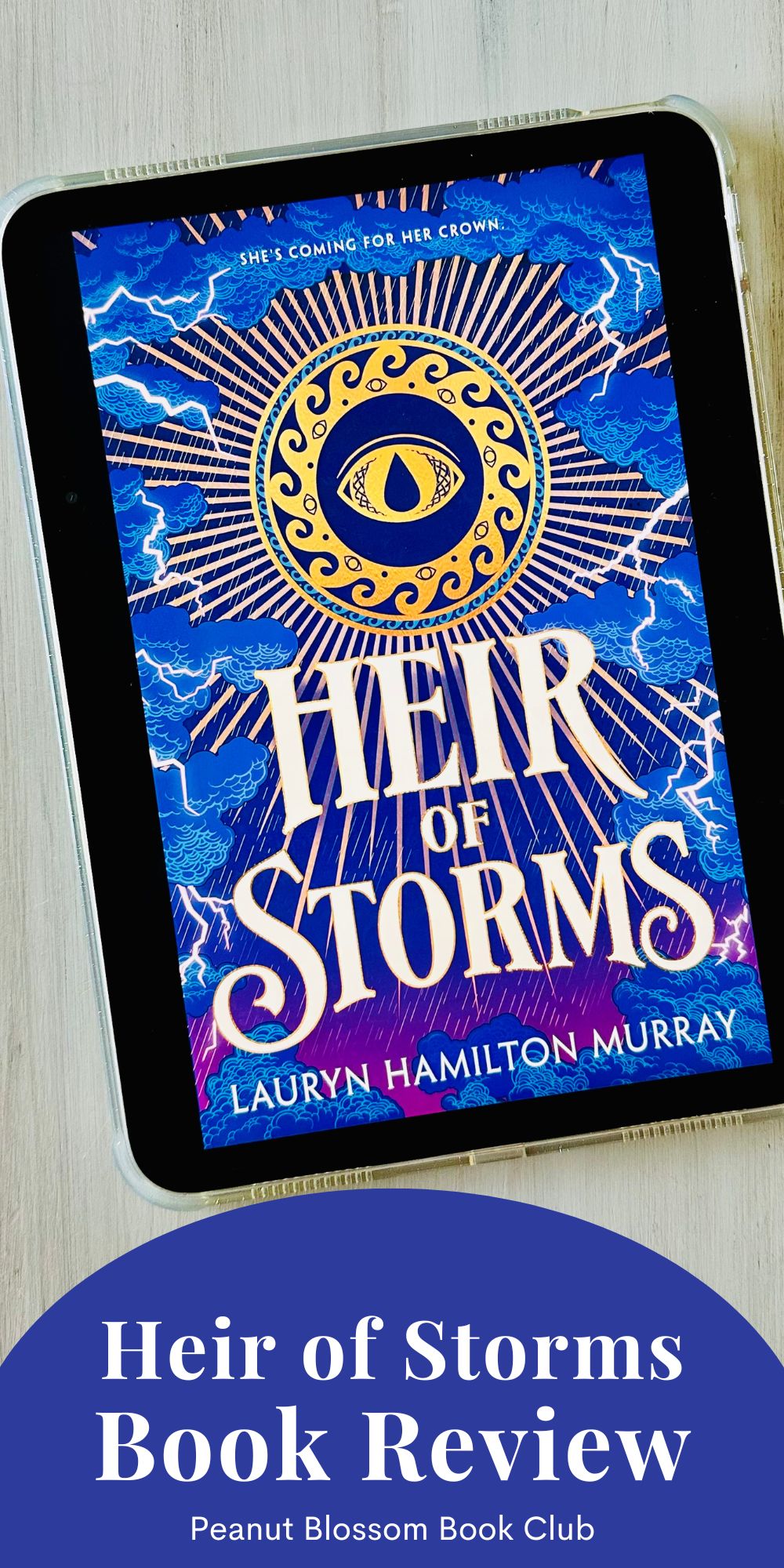 The cover of the book Heir of Storms by Lauryn Hamilton Murray is on the iPad screen.