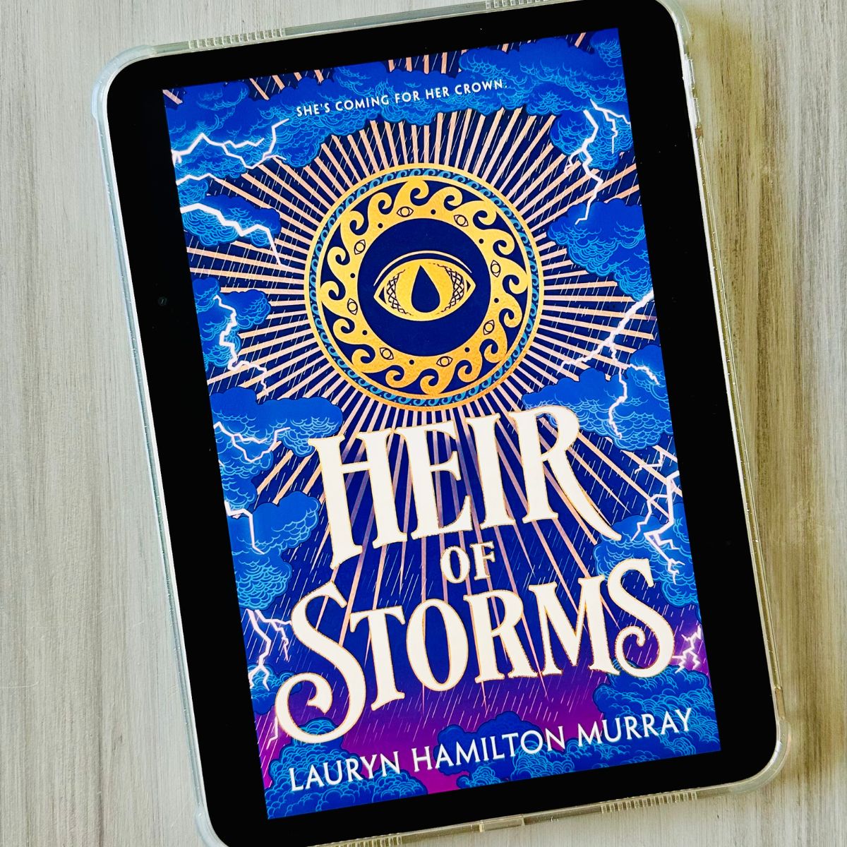 The cover of the book Heir of Storms by Lauryn Hamilton Murray is on the screen of an iPad.