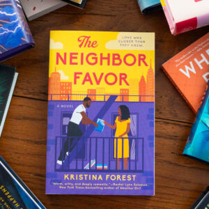 A copy of The Neighbor Favor by Kristina Forest sits on the table.