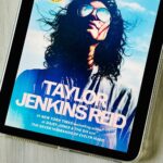 The cover of the book Atmosphere by Taylor Jenkins Reid is on the ipad screen.