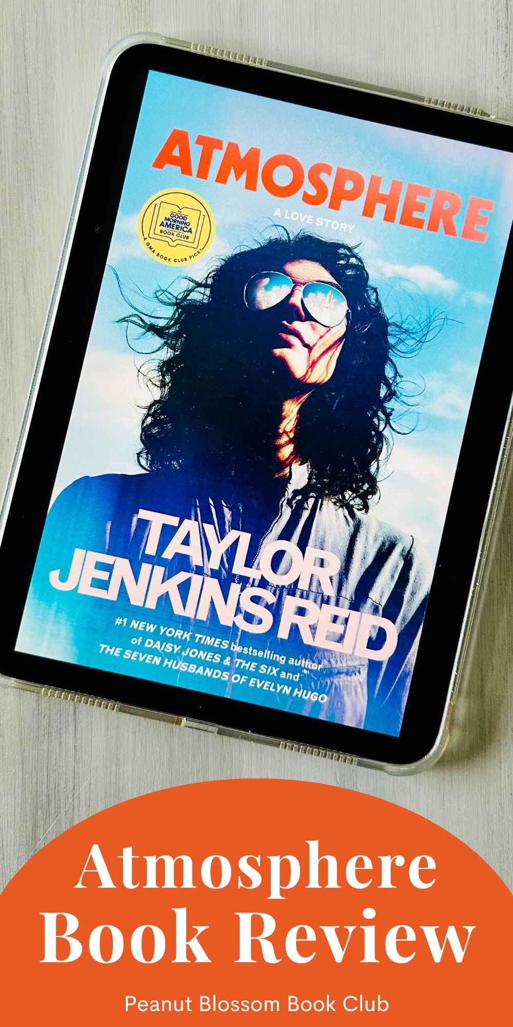 The cover of the book Atmosphere by Taylor Jenkins Reid is on the ipad screen.