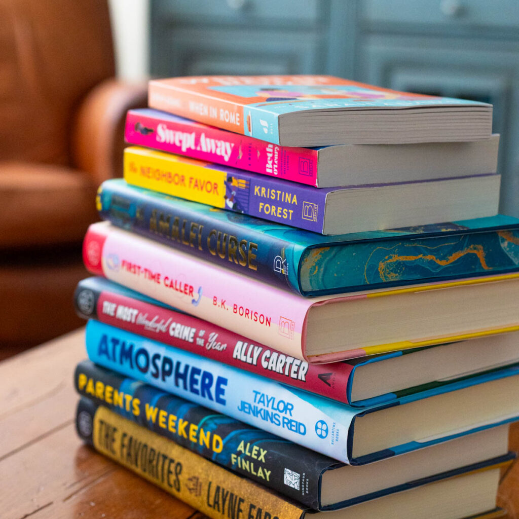 A stack of the best Book Club Books for 2026 sits on the table.
