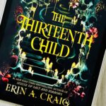 The cover of the book The Thirteenth Child by Erin A. Craig is on the ipad screen