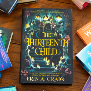 A copy of the book The Thirteenth Child by Erin A. Craig sits on the table.