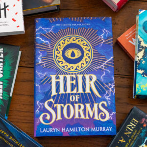 A copy of Heir of Storms by Lauryn Hamilton Murray sits on the table.