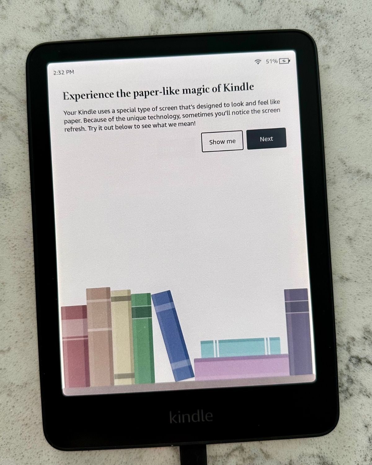 A colorful illustration of book spines on the cover of the Kindle Colorsoft.