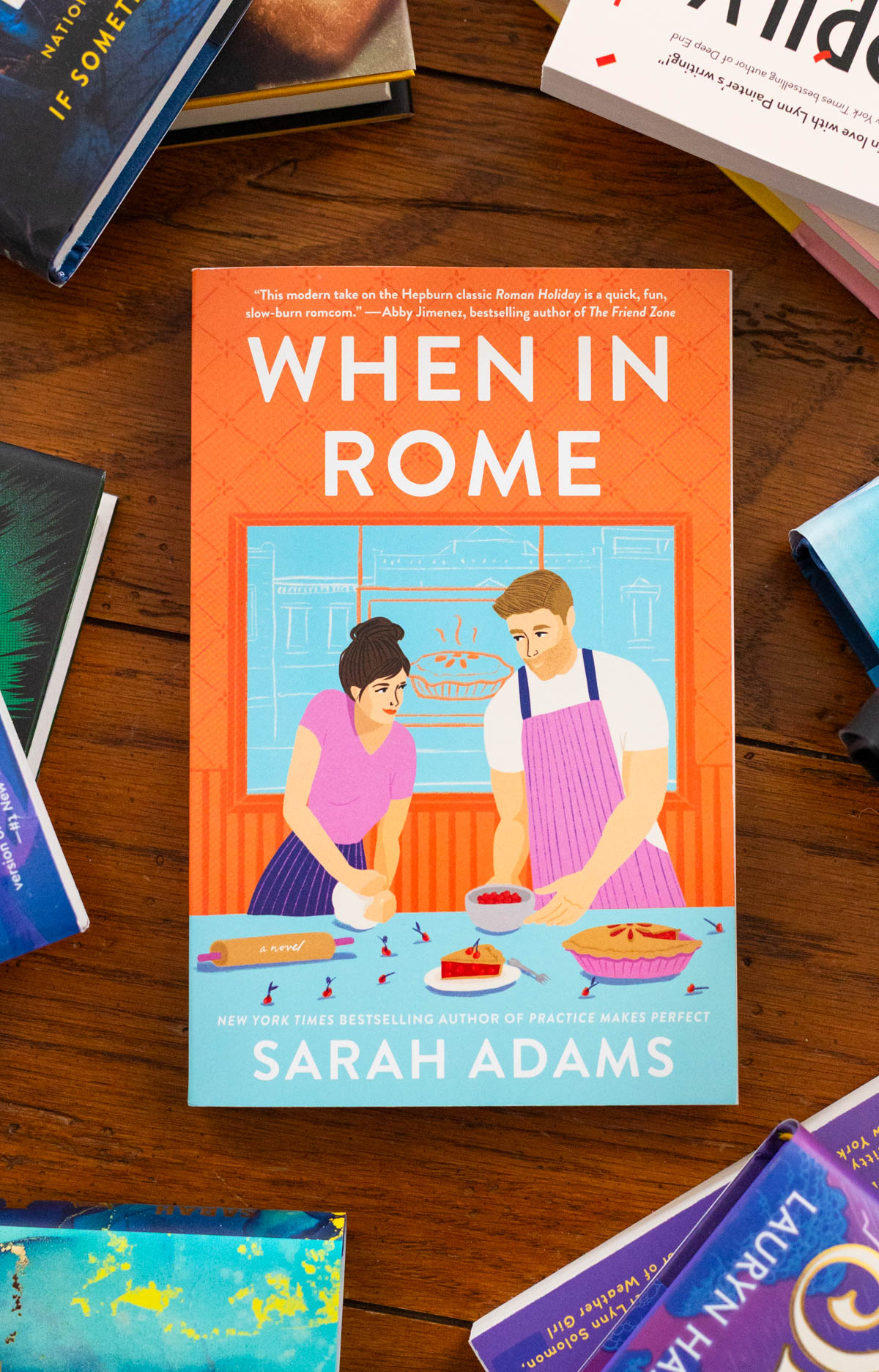 A copy of the book When in Rome by Sarah Adams sits on the table.