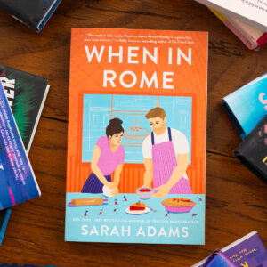 A copy of the book When in Rome by Sarah Adams sits on the table.