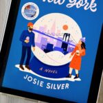 The cover of the book A Winter in New York by Josie Silver is on the screen of an ipad.