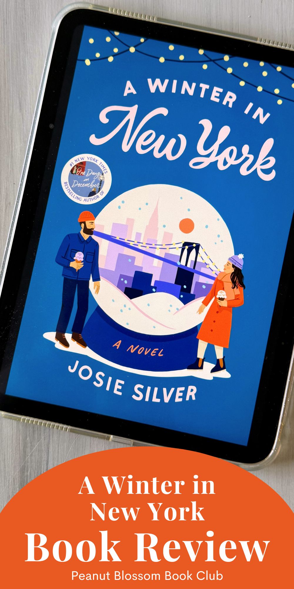 The cover of the book A Winter in New York by Josie Silver is on the screen of an ipad.