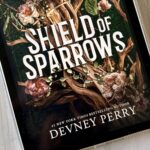 The cover of the book Shield of Sparrows by Devney Perry is on the screen of an ipad.
