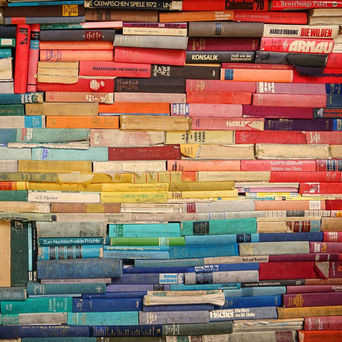 A rainbow colored stack of books.